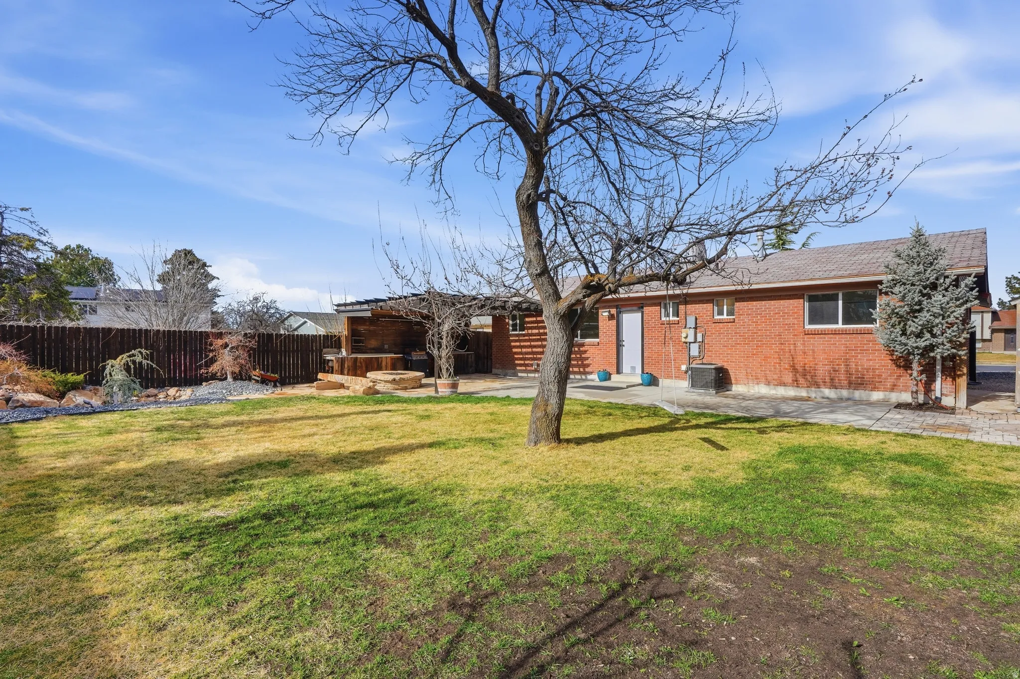 Rear view of property featuring brick siding and a patio area