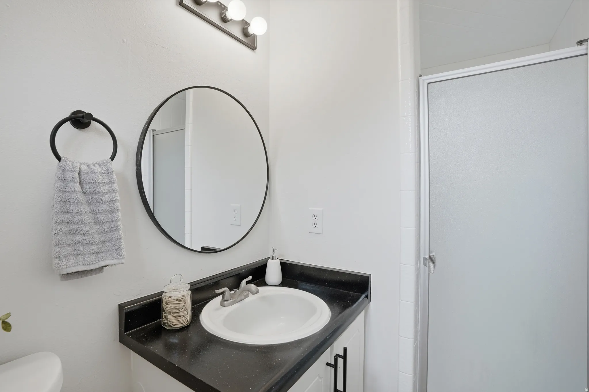 Bathroom featuring vanity and a stall shower