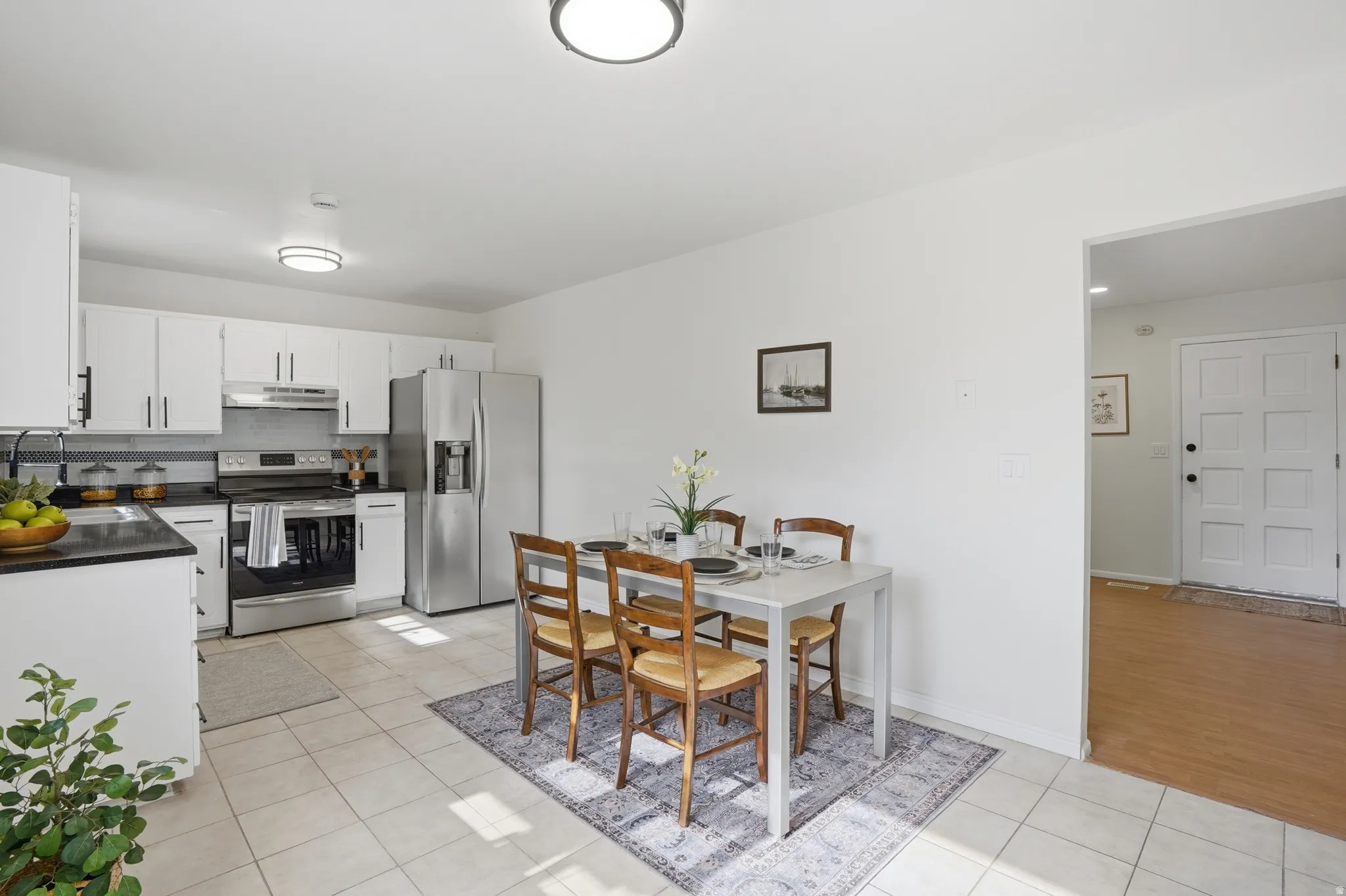 Dining area featuring light tile patterned flooring and baseboards