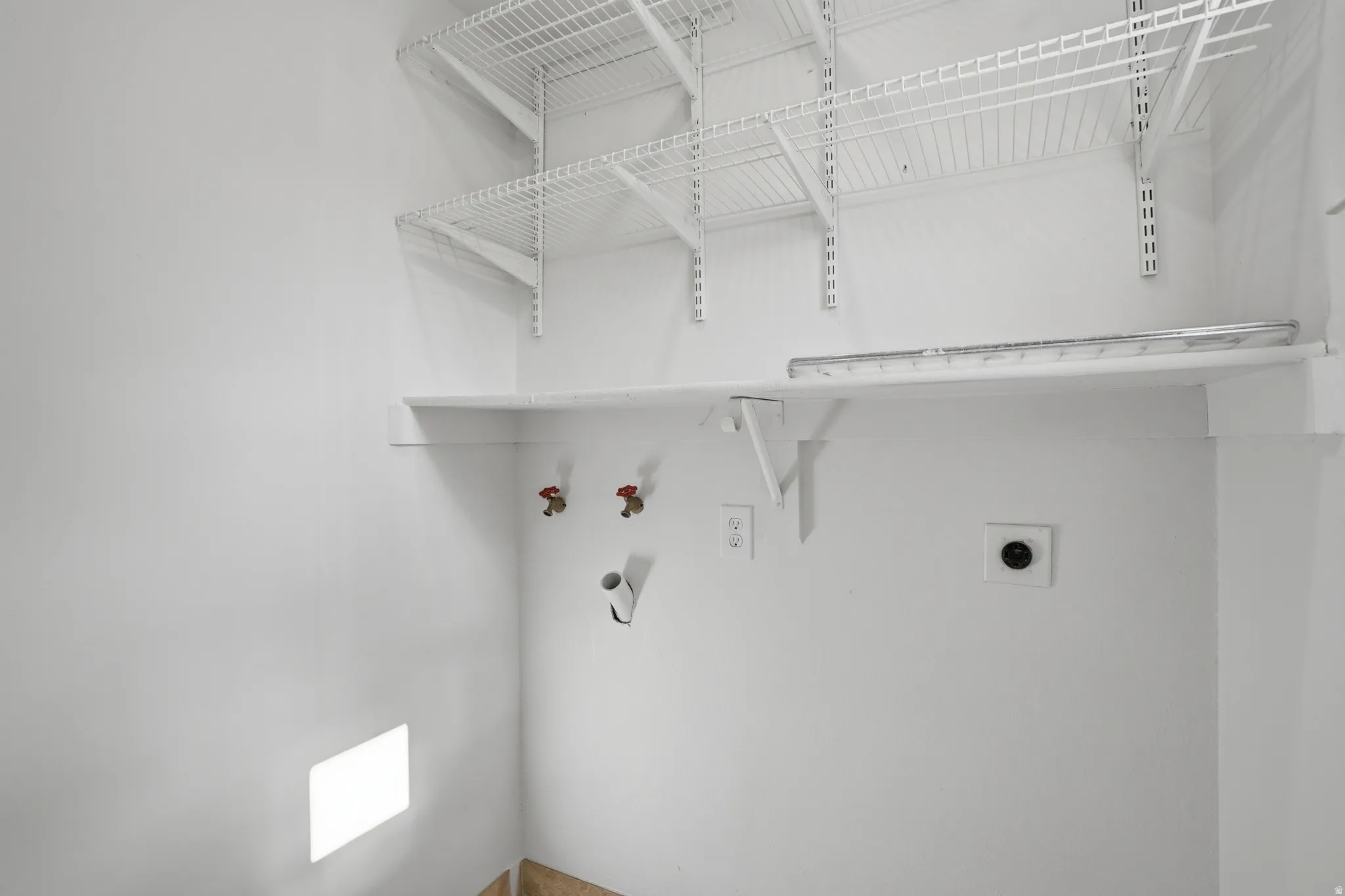 Laundry area with hookup for a washing machine and electric dryer hookup