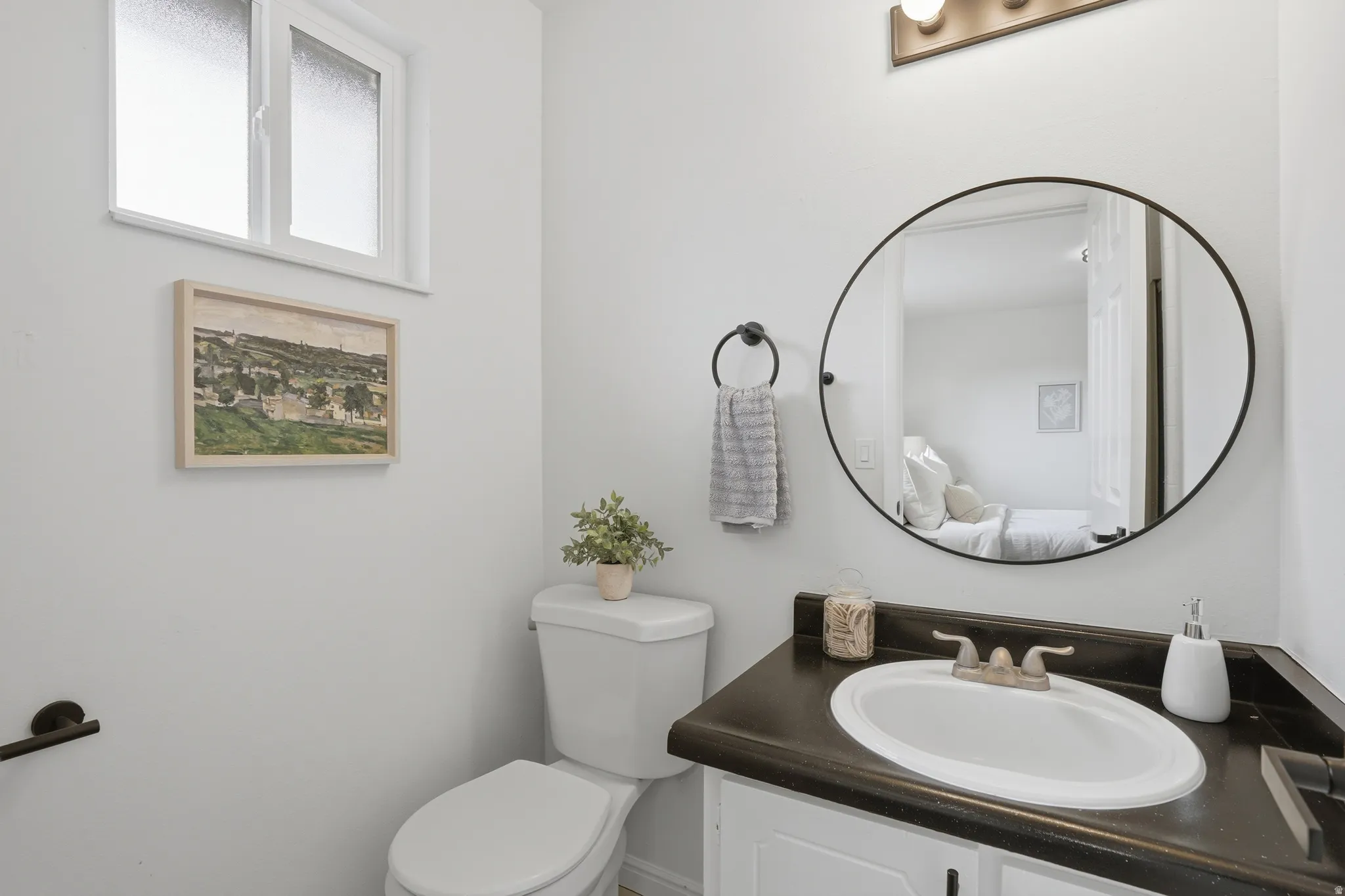 Half bathroom with vanity and toilet