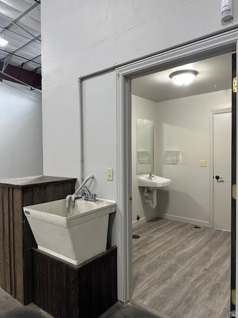 Bathroom with dark wood finished floors and a sink