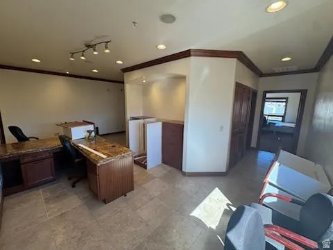 Office space featuring ornamental molding and recessed lighting