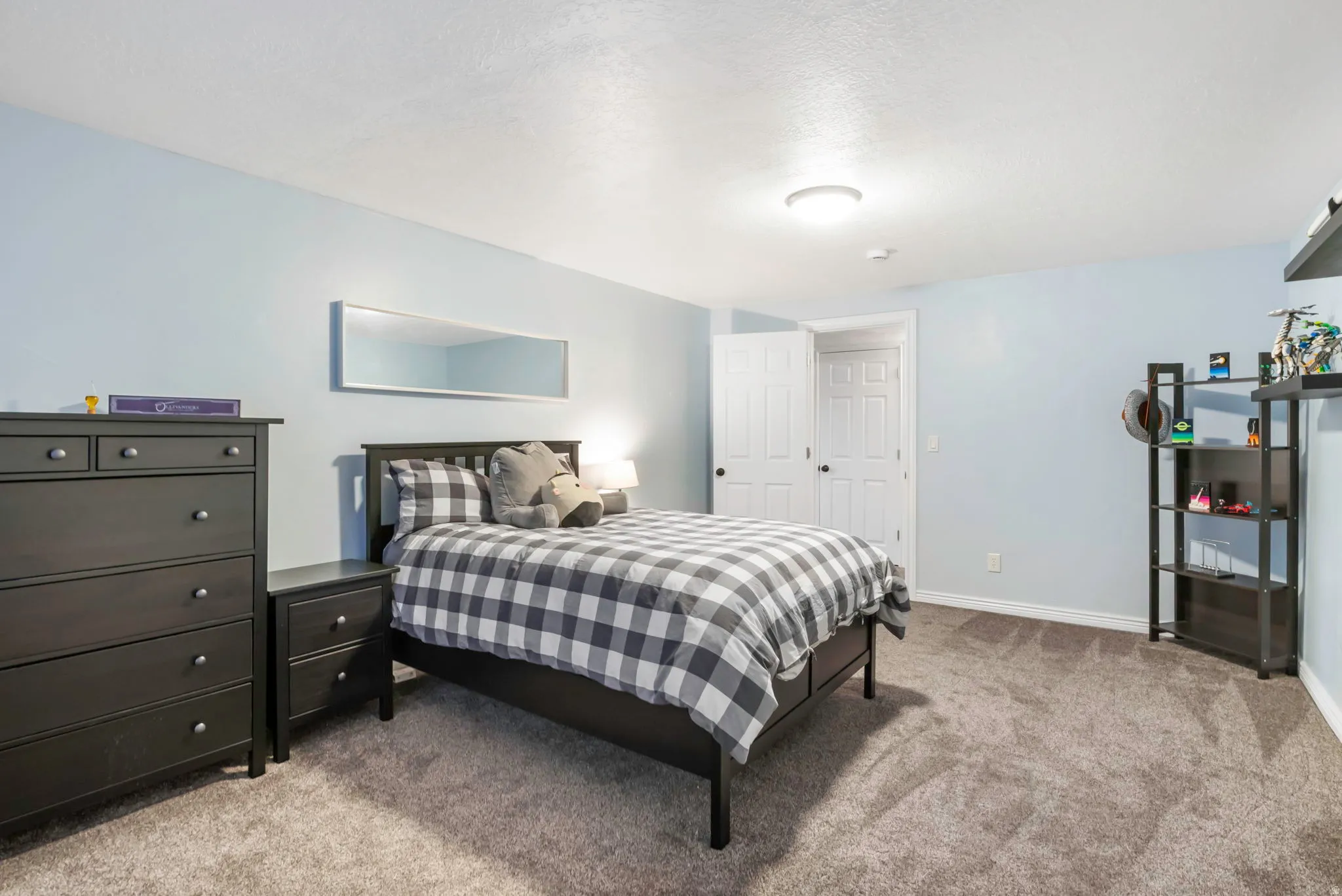 Bedroom featuring light colored carpet and a textured ceiling