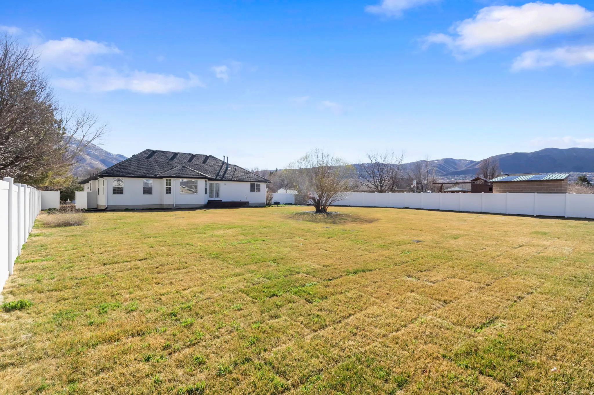 Fenced backyard with a mountain view