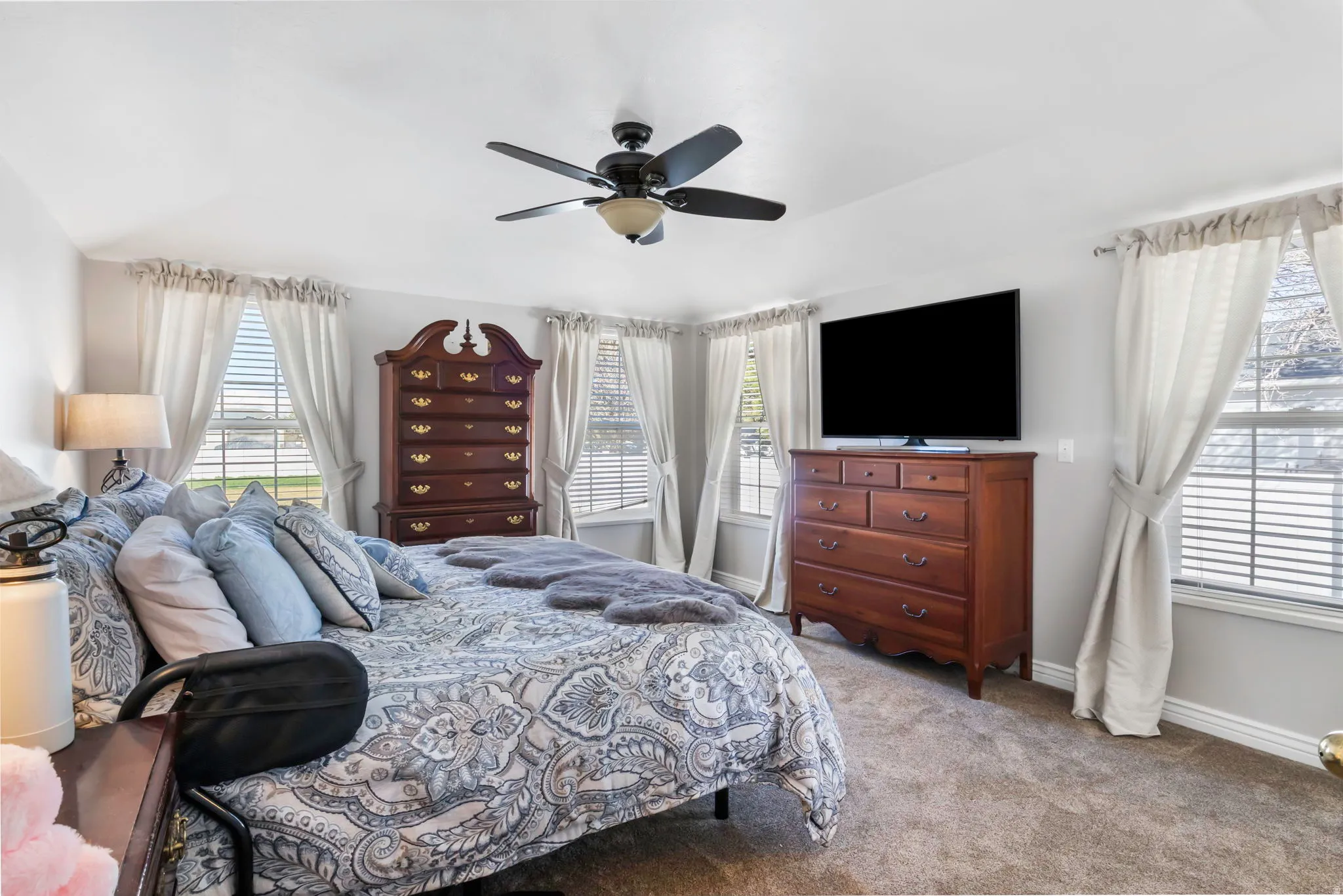 Bedroom with carpet floors, ceiling fan, and lofted ceiling
