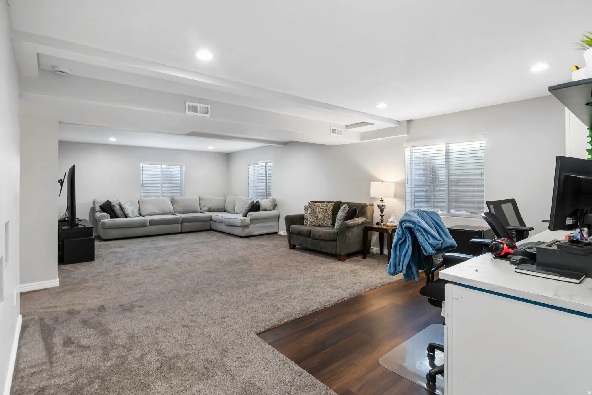 Office featuring dark colored carpet and recessed lighting