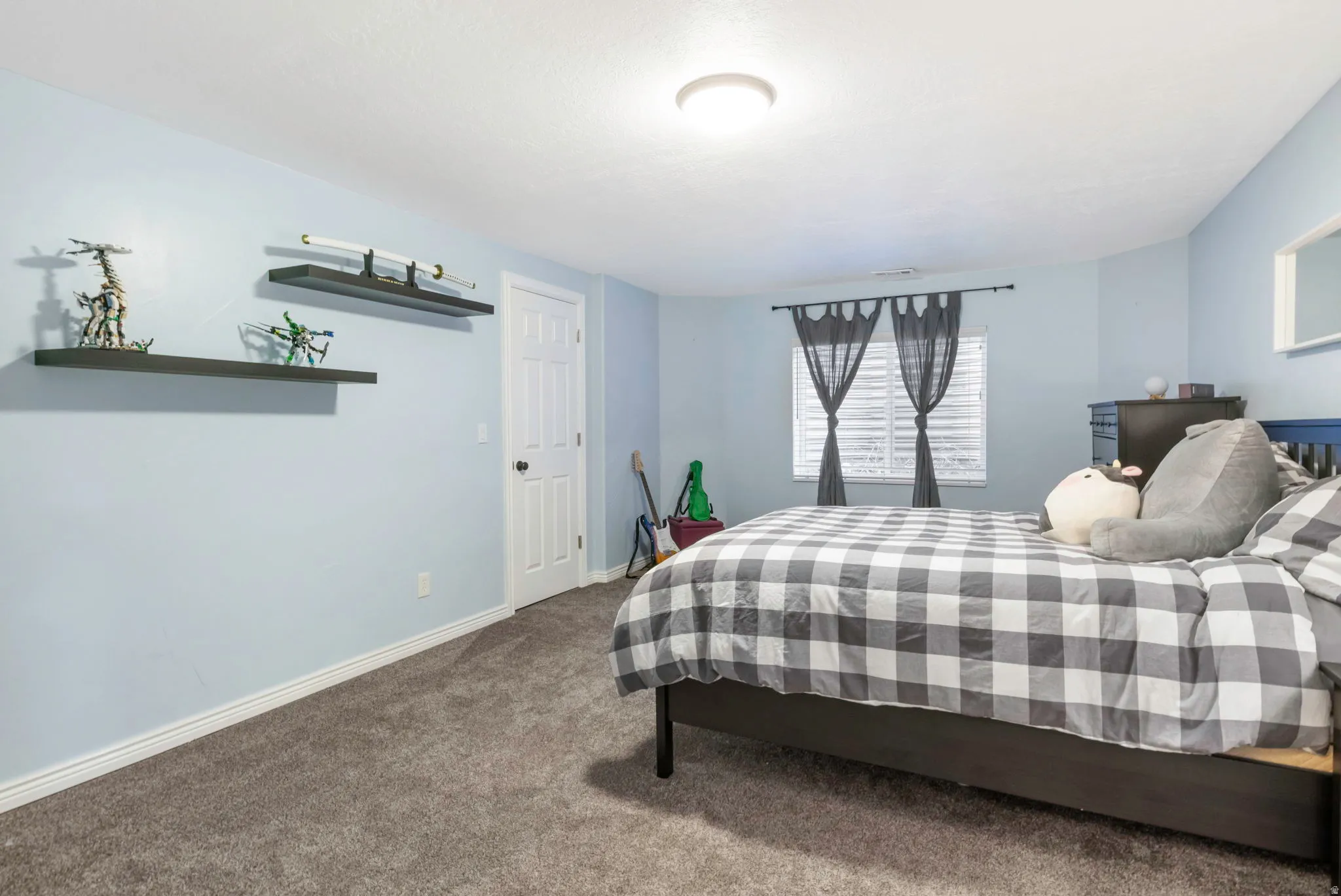 Carpeted bedroom with baseboards