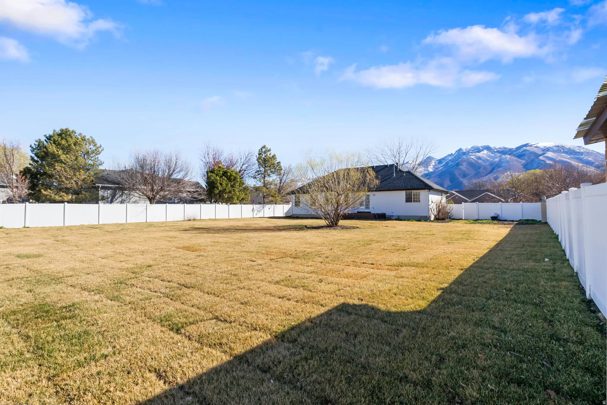 Fenced backyard with a mountain view