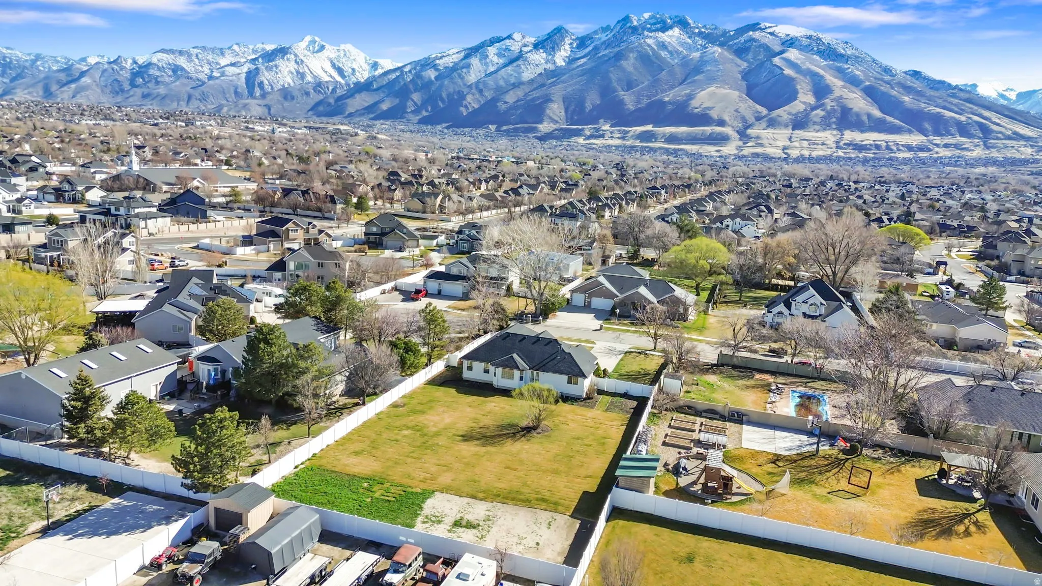 Aerial perspective of suburban area featuring a mountain backdrop