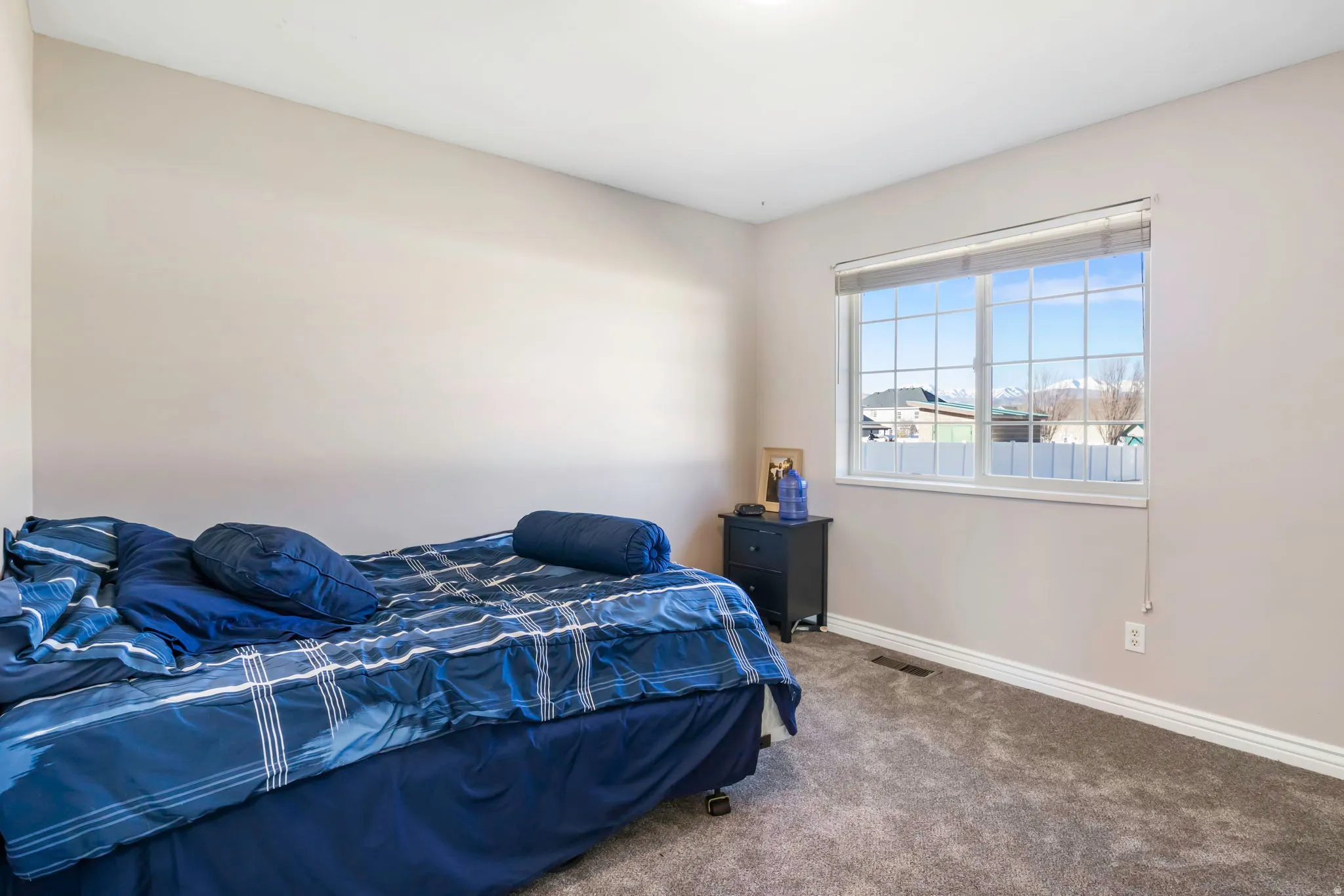 Carpeted bedroom with baseboards