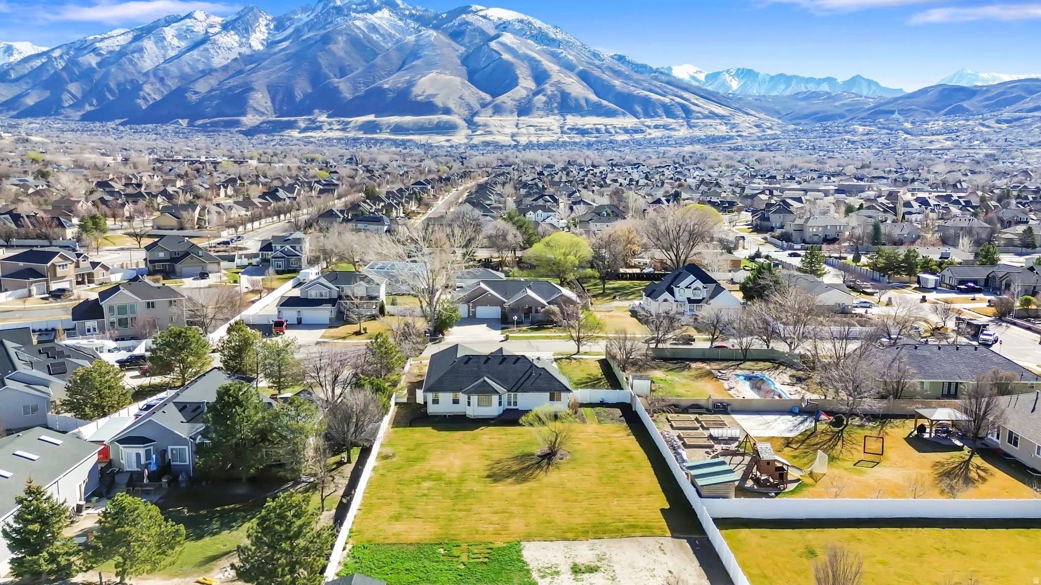 Aerial perspective of suburban area featuring a mountainous background