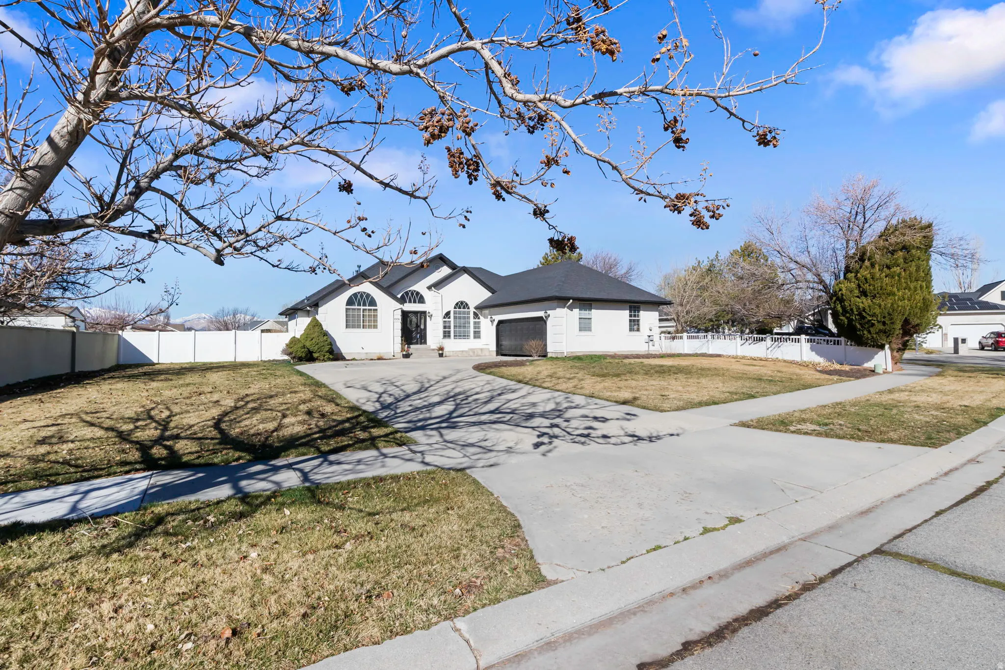 Single story home with concrete driveway and a garage