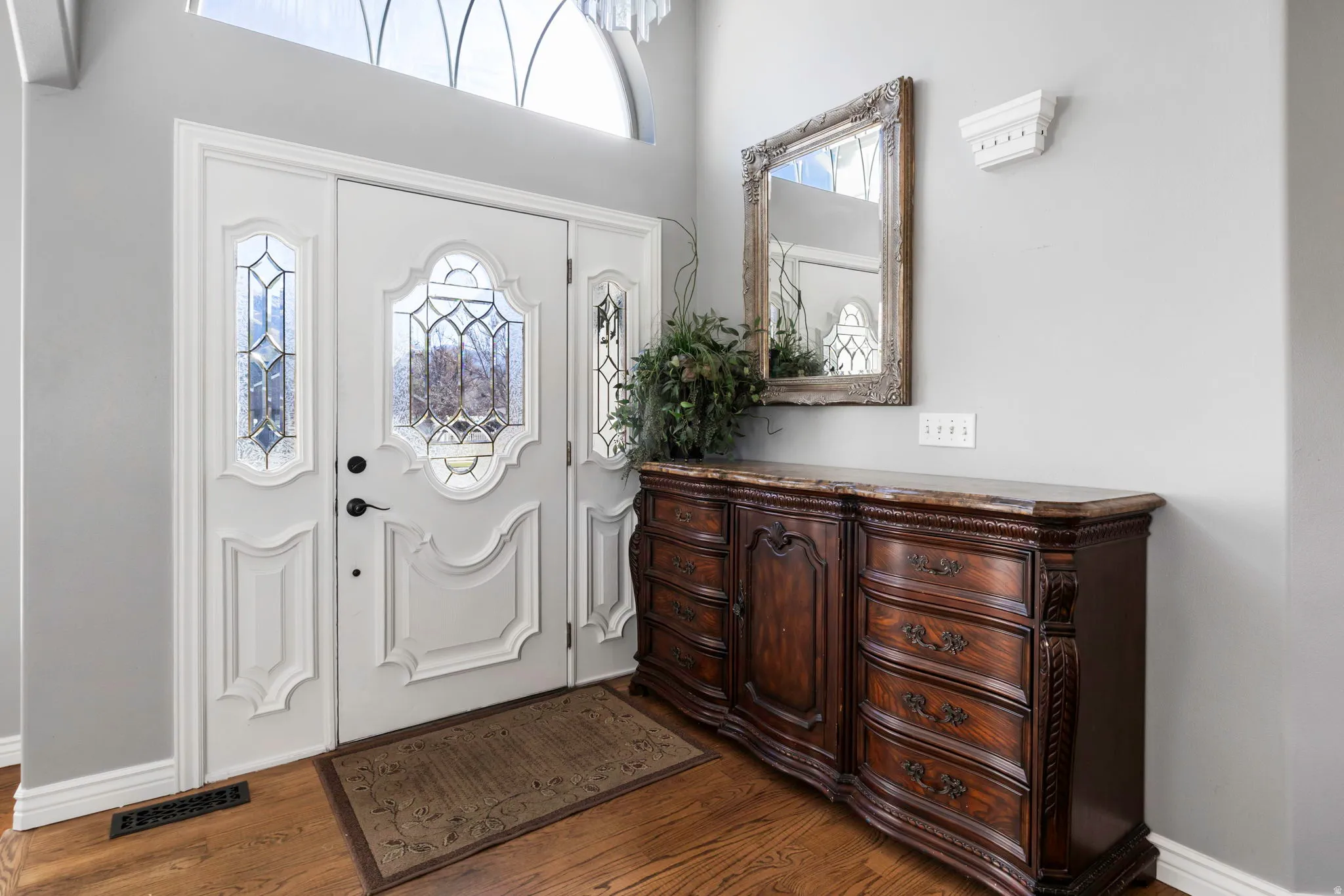 Foyer with dark wood-style flooring