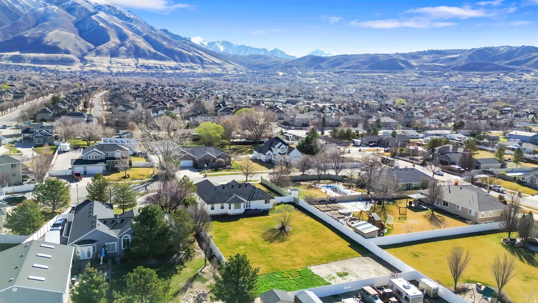 Aerial overview of property's location featuring nearby suburban area and mountains