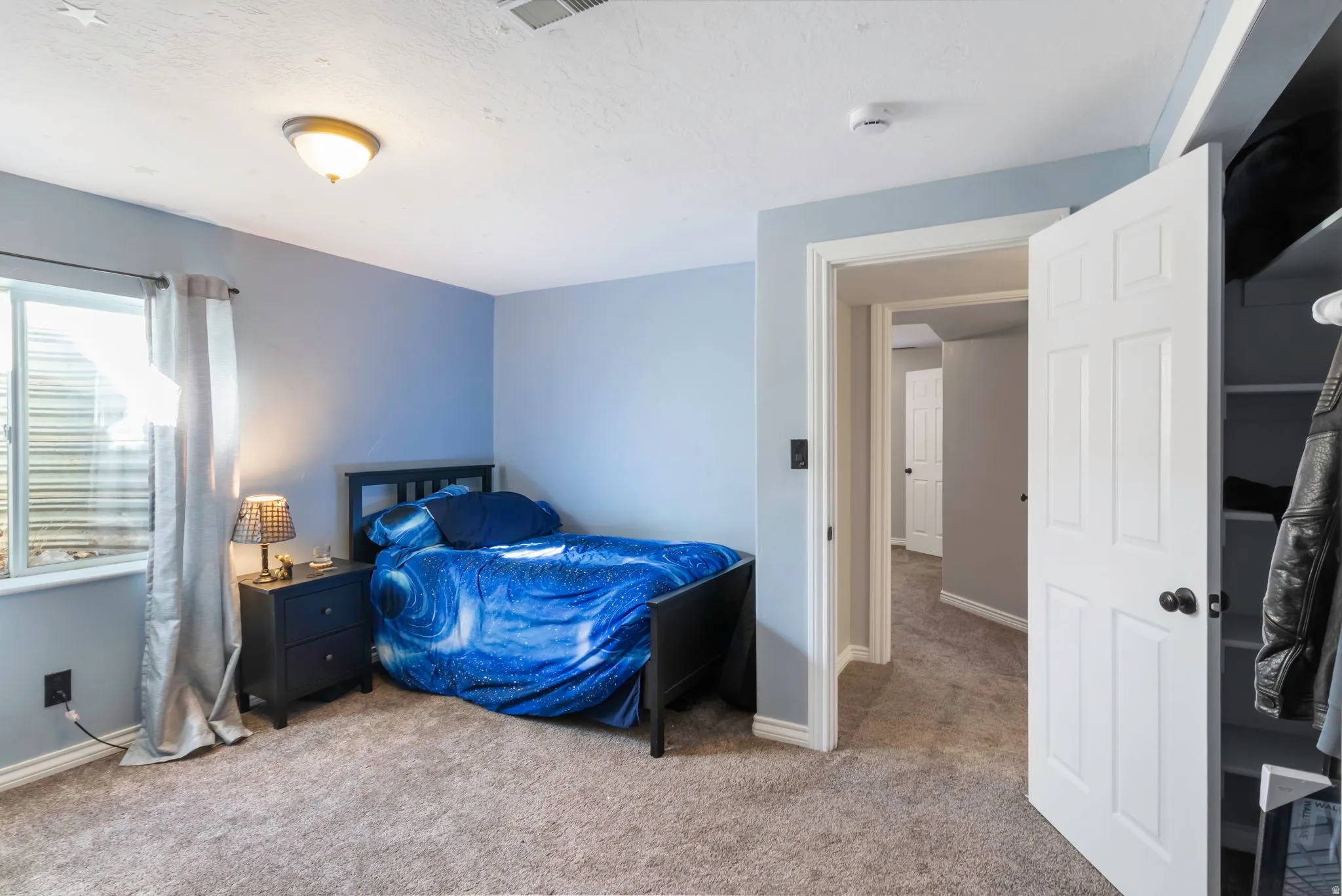 Bedroom with light carpet and baseboards