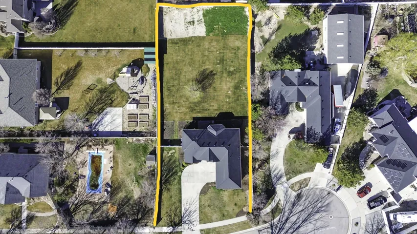 Aerial view of residential area with property boundaries highlighted