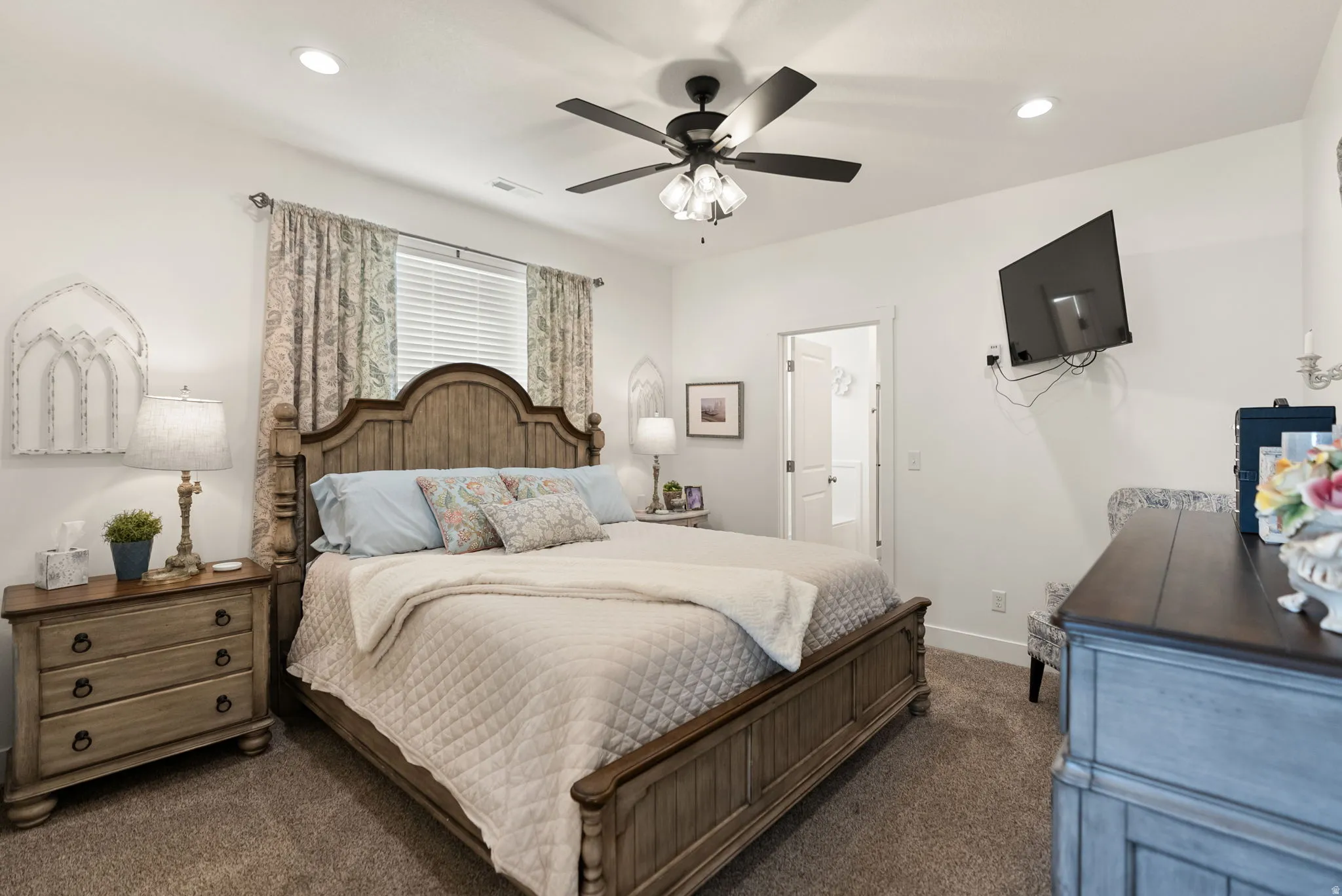 Primary bedroom with carpet, ceiling fan, and recessed lighting
