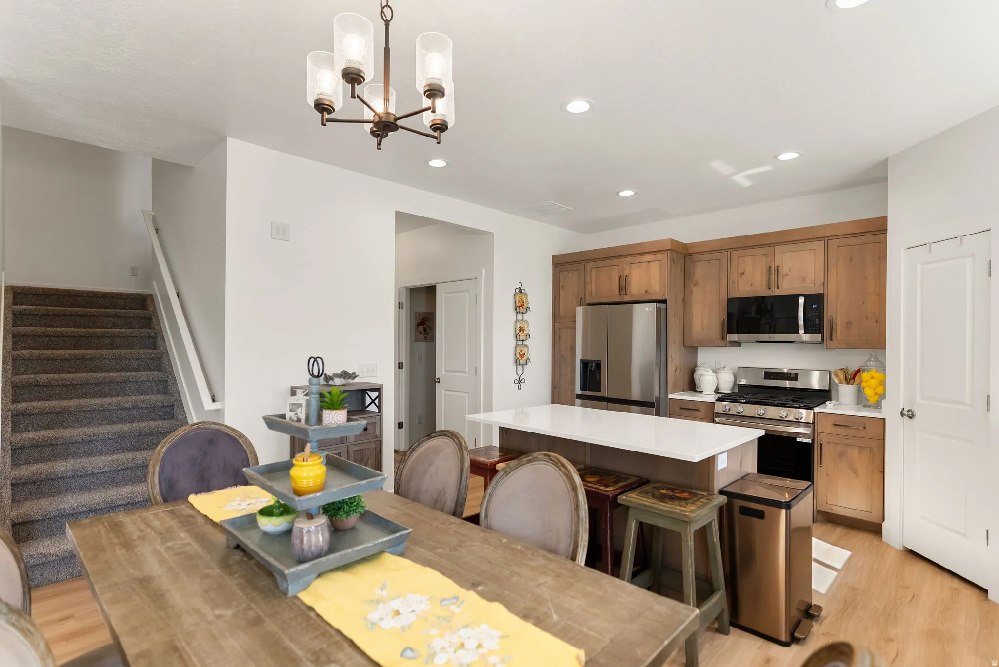 Dining space with light wood-style flooring and a chandelier