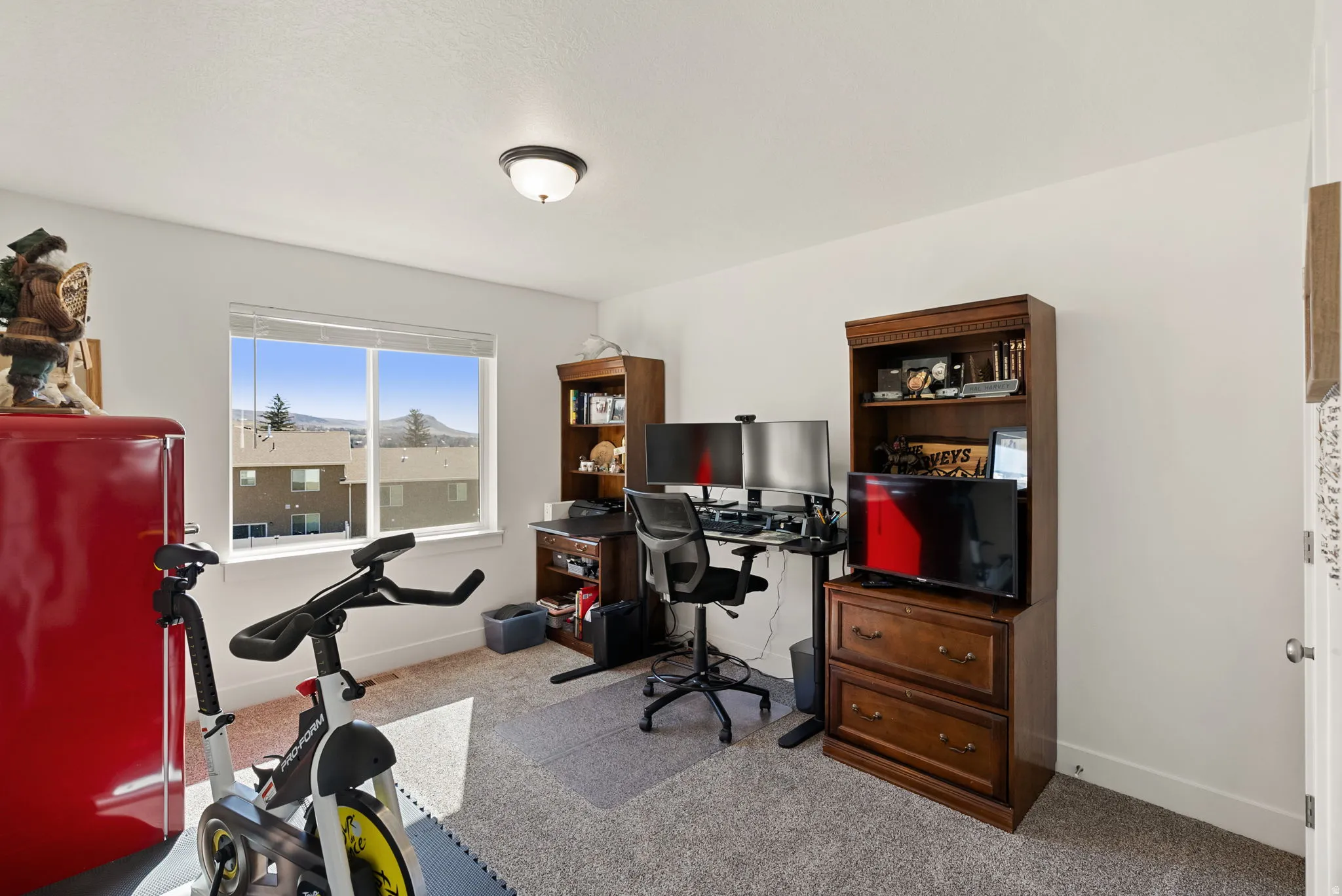 Bedroom featuring light carpet and baseboards