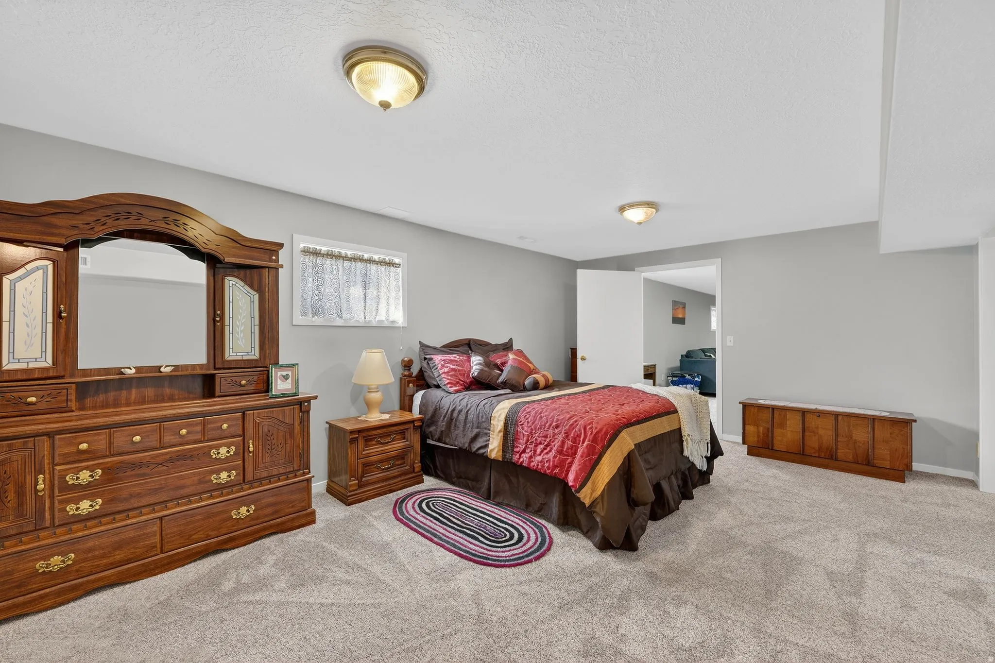 Bedroom featuring light carpet and a textured ceiling