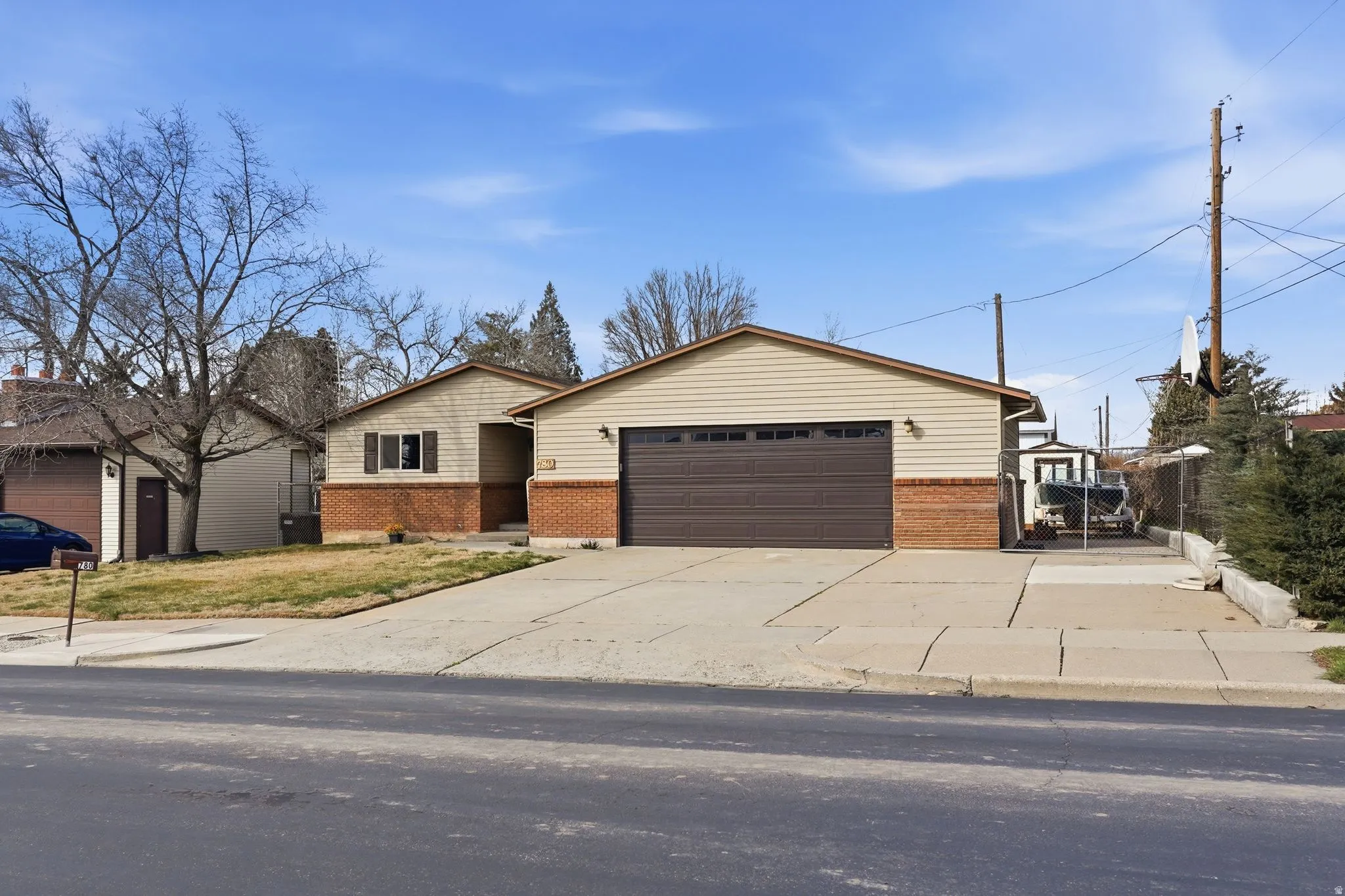 View of front facade featuring brick siding, an attached garage, and driveway