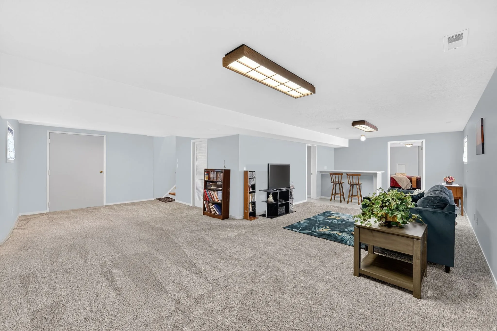 Living area with light carpet and stairway