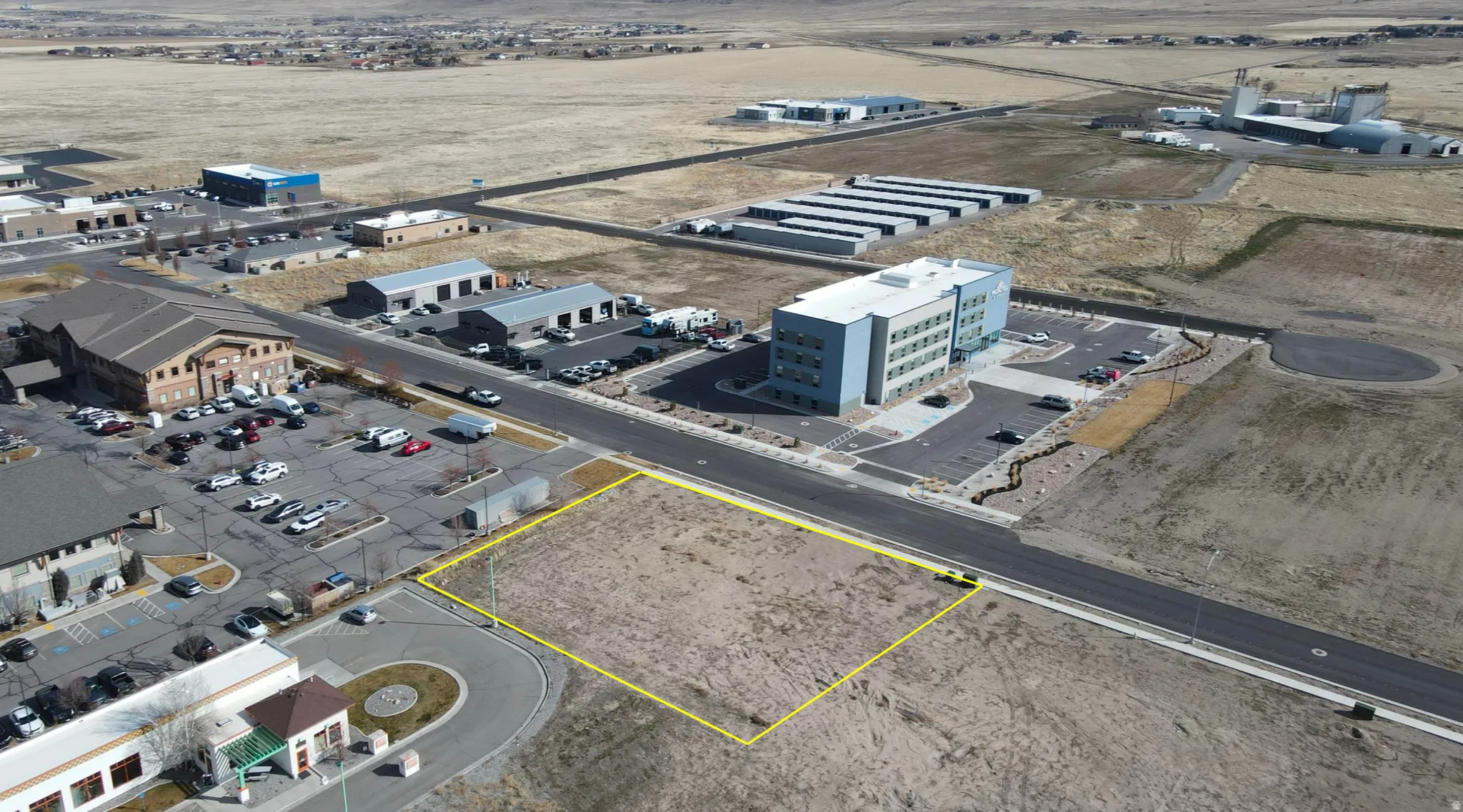 Aerial view of property and surrounding area featuring property boundaries highlighted and an industrial area