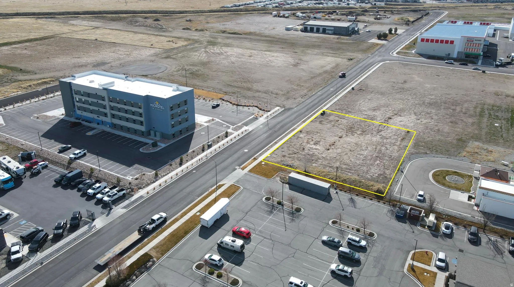 Aerial view of property and surrounding area with property parcel outlined