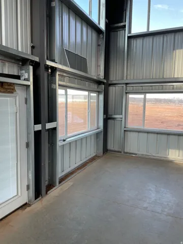 Interior space with unfinished concrete floors and plenty of natural light
