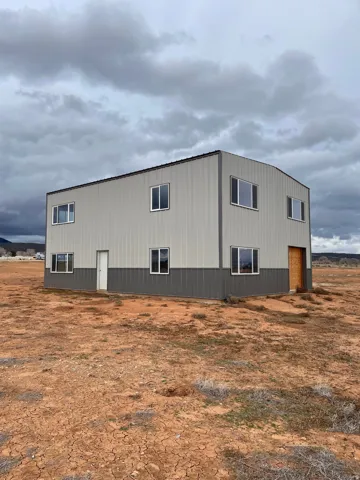 View of home's exterior featuring an outdoor structure and an outbuilding