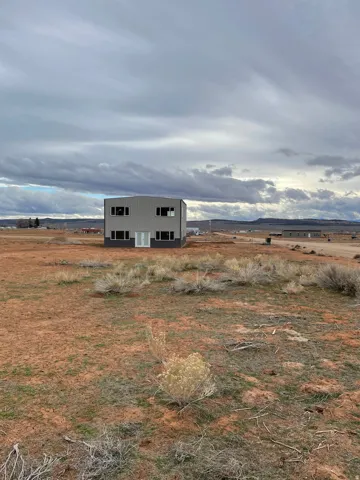 Exterior space with an outdoor structure, a view of countryside, and a pole building