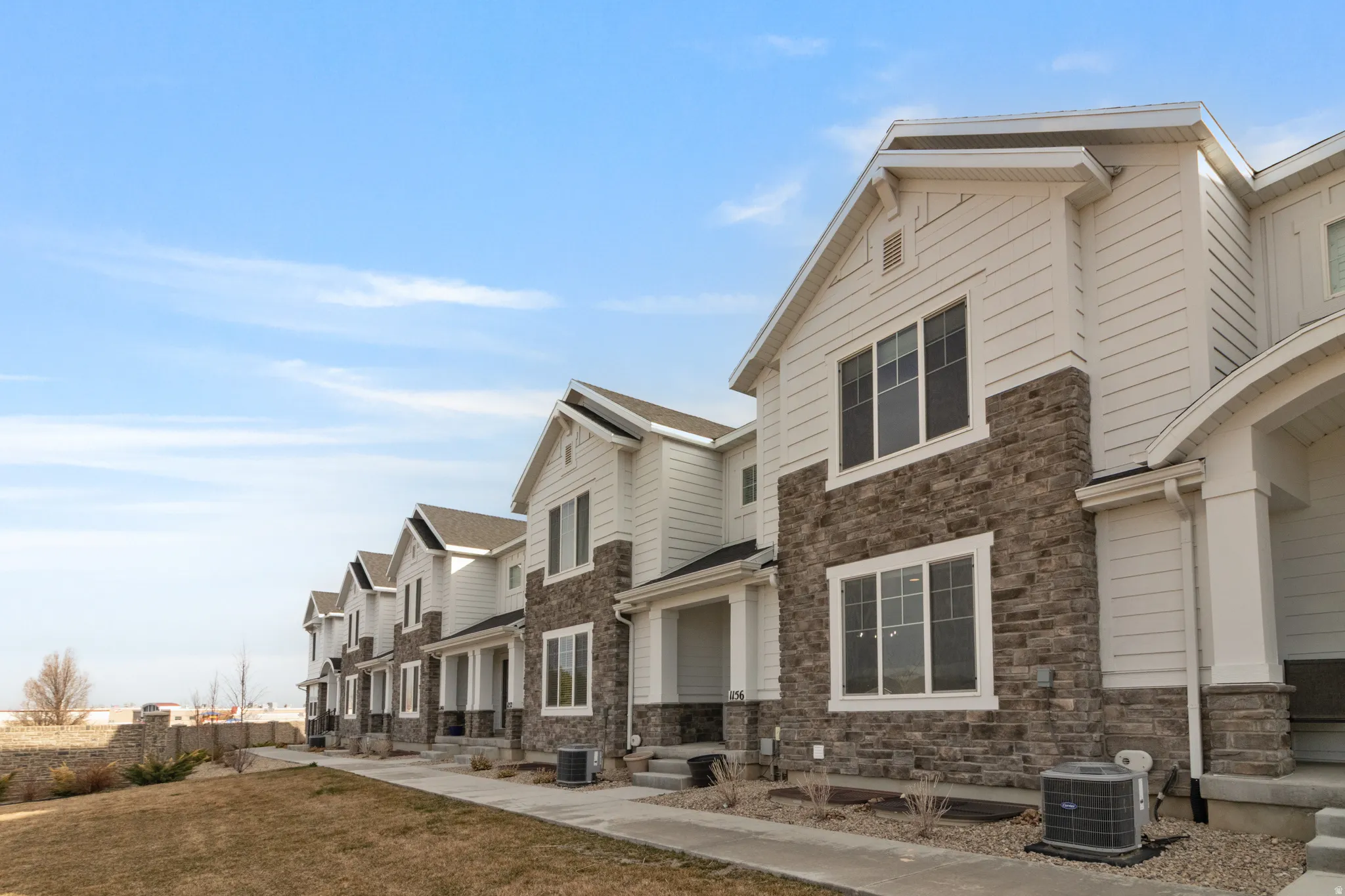 View of side of home featuring a residential view and stone siding
