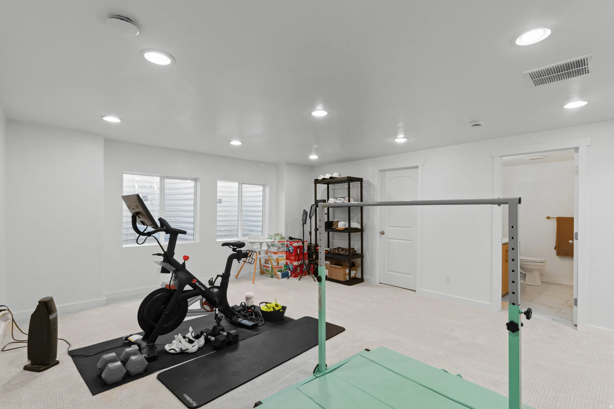 Exercise area featuring light colored carpet and recessed lighting