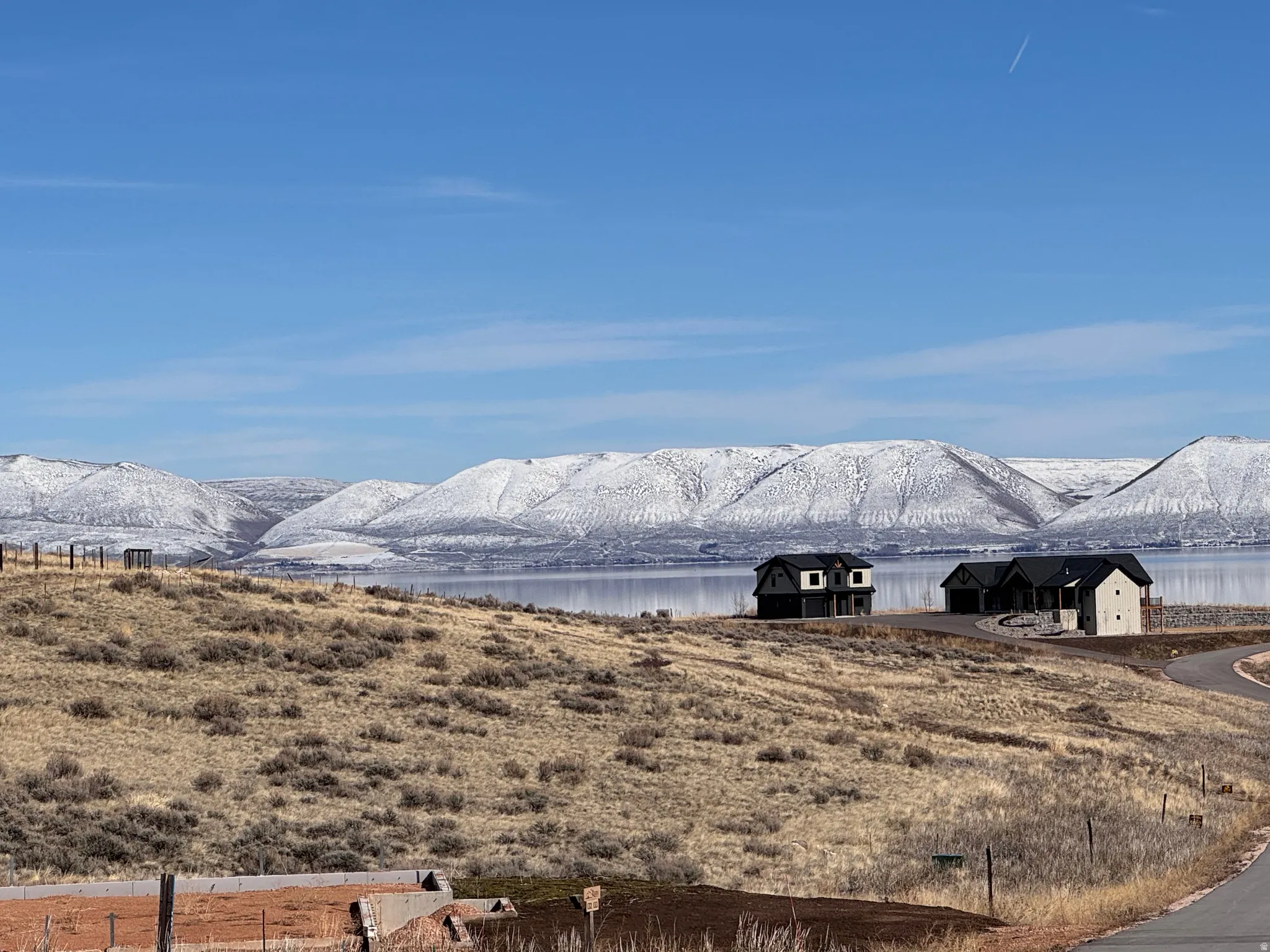 View of mountain backdrop featuring a nearby body of water