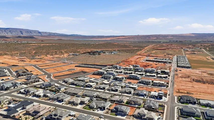 Aerial view of property and surrounding area with nearby suburban area and a mountain backdrop