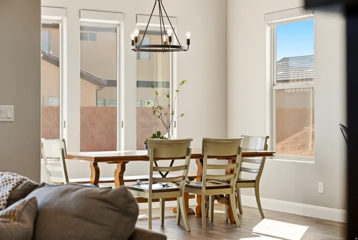 Dining area with light wood-style flooring and hanging lights