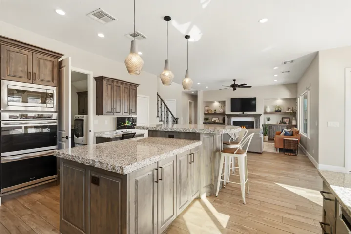 Kitchen featuring light stone counters, a kitchen breakfast bar, stainless steel appliances, and a center island