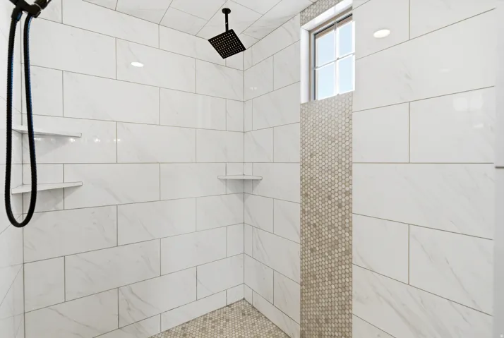 Full bath with a tile shower
