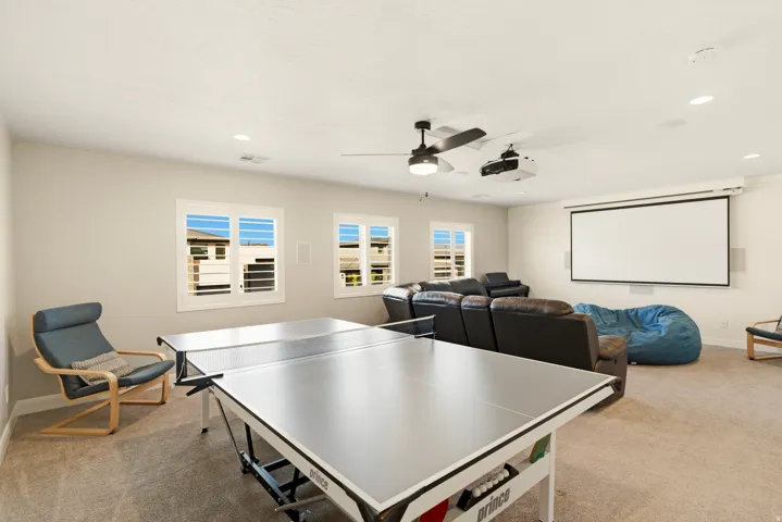 Rec room featuring light colored carpet, a ceiling fan, and recessed lighting