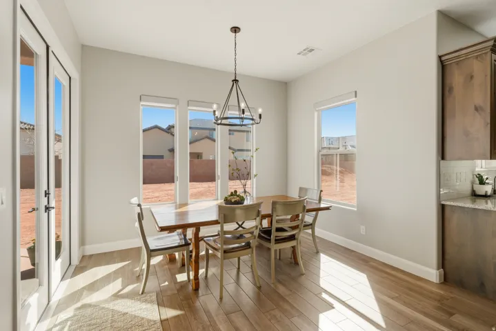 Dining space with light wood-type flooring and hanging lights