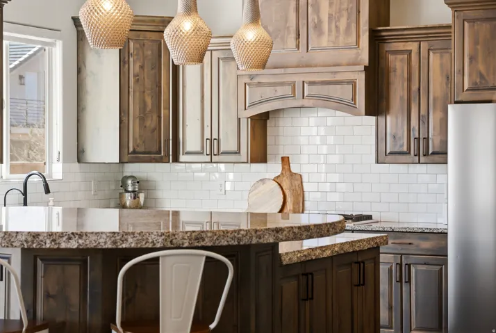 Kitchen with dark wood finish cabinets and light stone countertops