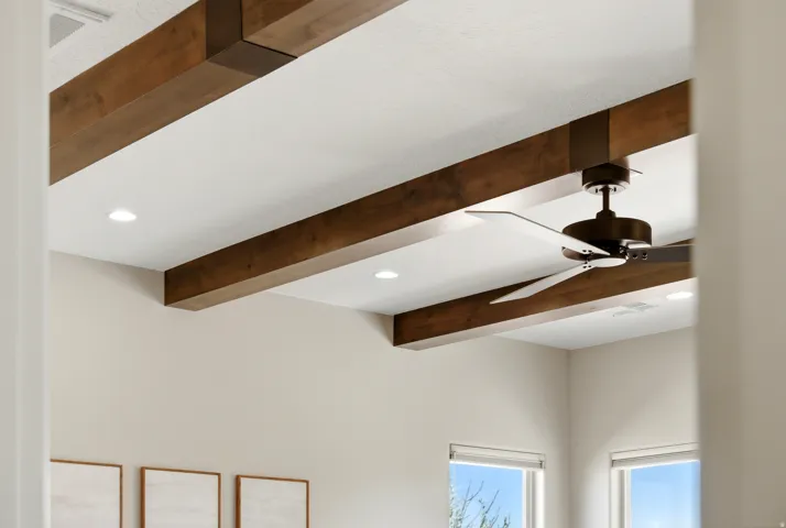 Detailed view of recessed lighting, beamed ceiling, and a ceiling fan