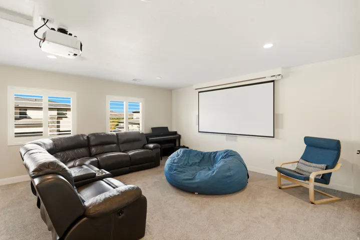 Home theater featuring light colored carpet and recessed lighting