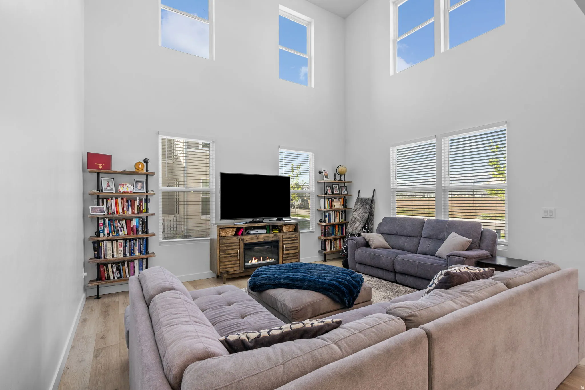 Living area with hardwood / wood-style floors and a high ceiling