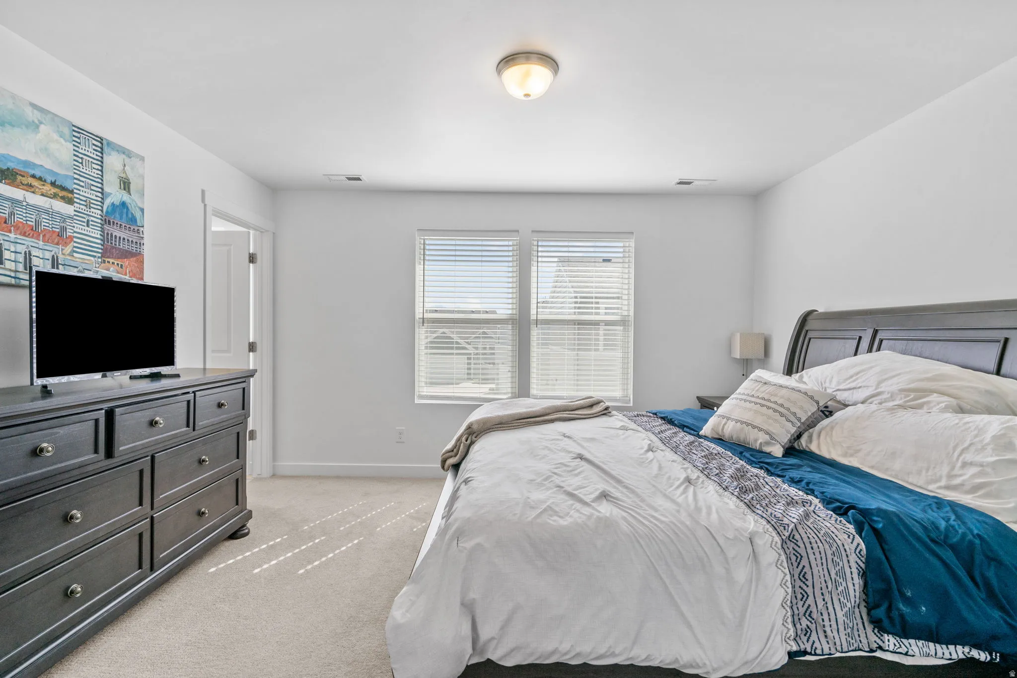 Bedroom with light carpet and baseboards