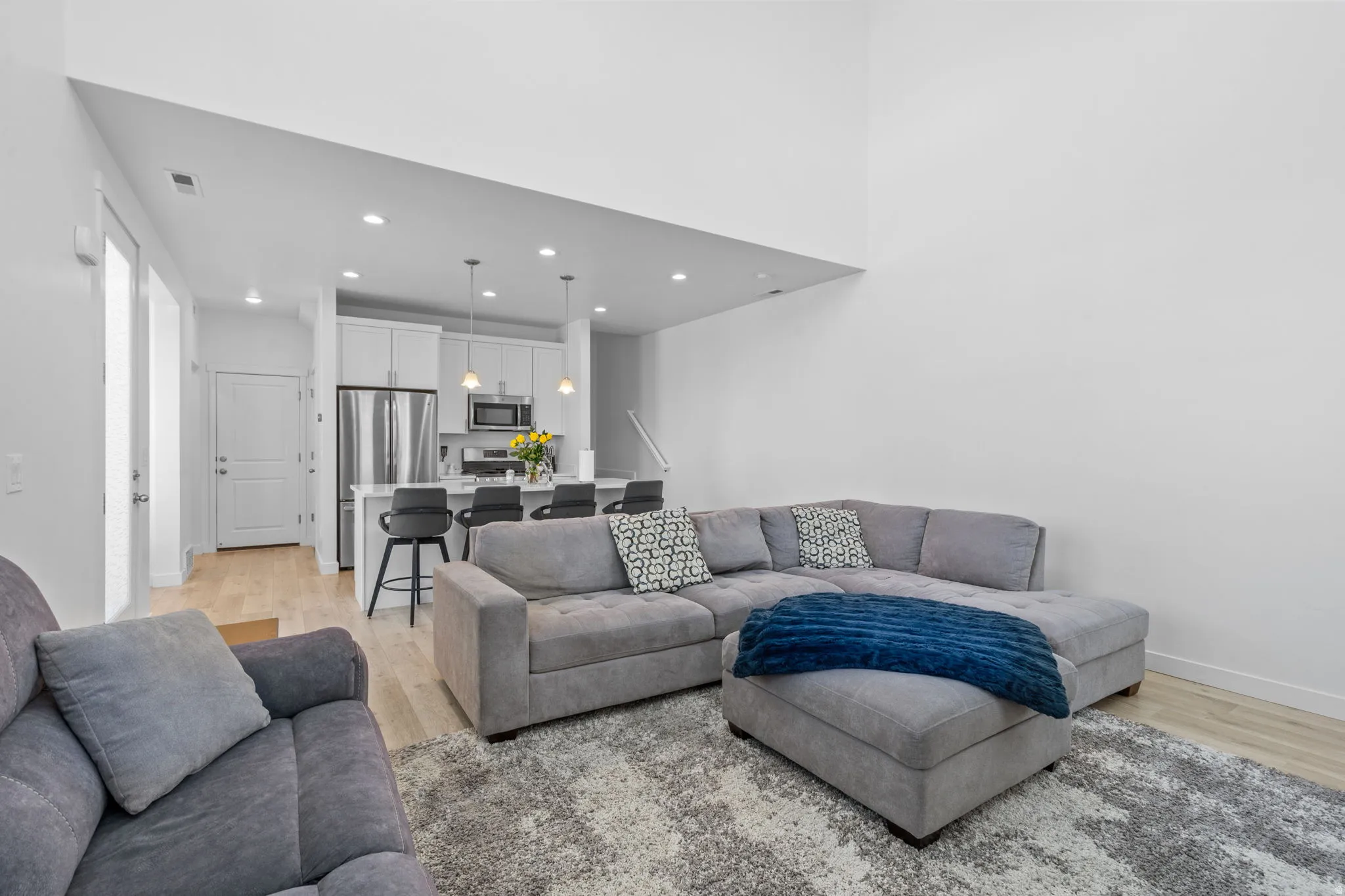 Living area featuring light wood-type flooring and recessed lighting