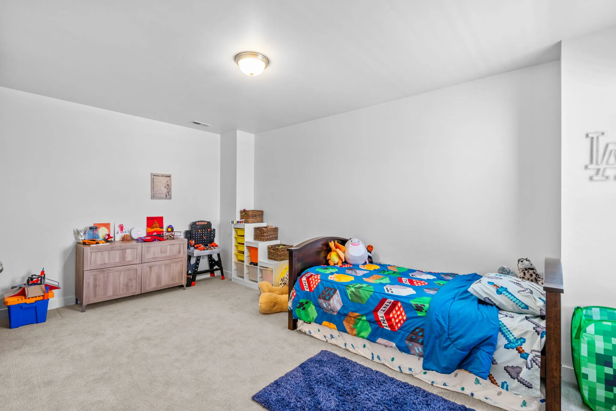 Bedroom featuring light carpet
