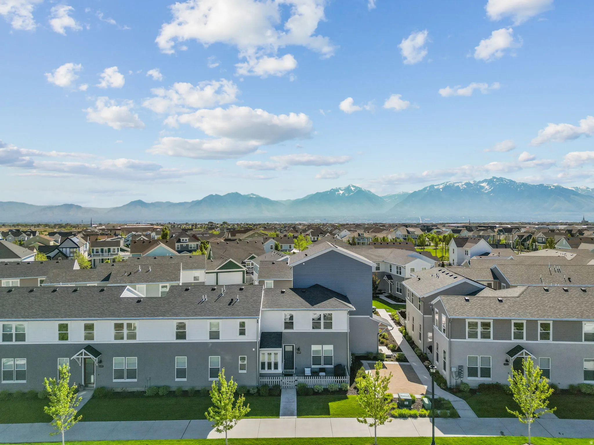 Aerial view of residential area featuring a mountainous background
