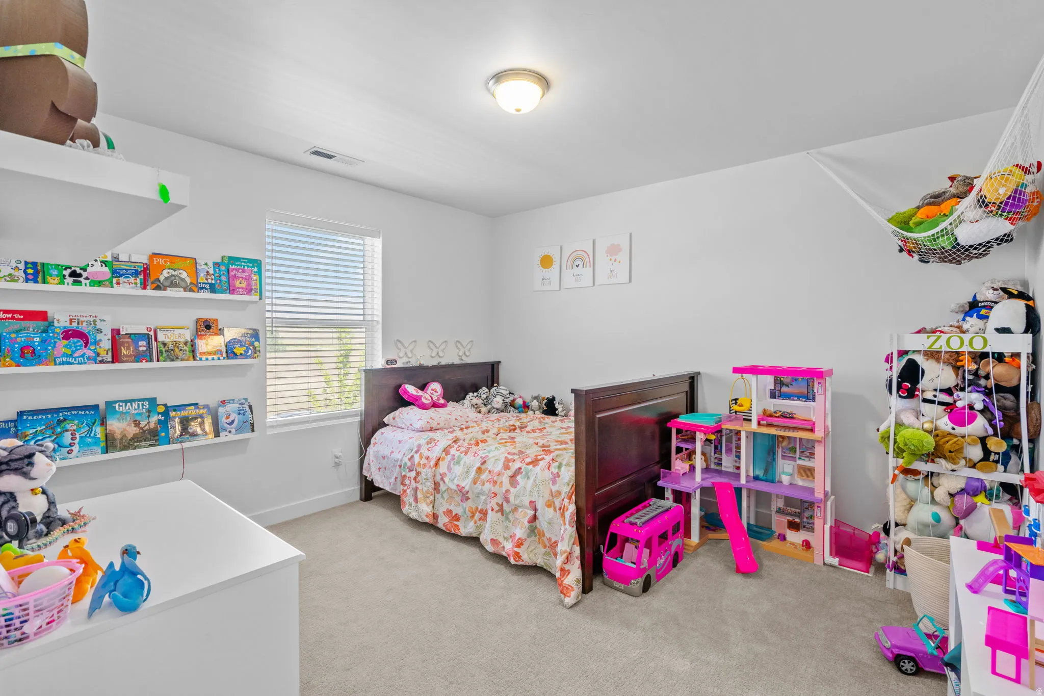 Bedroom with light carpet and baseboards